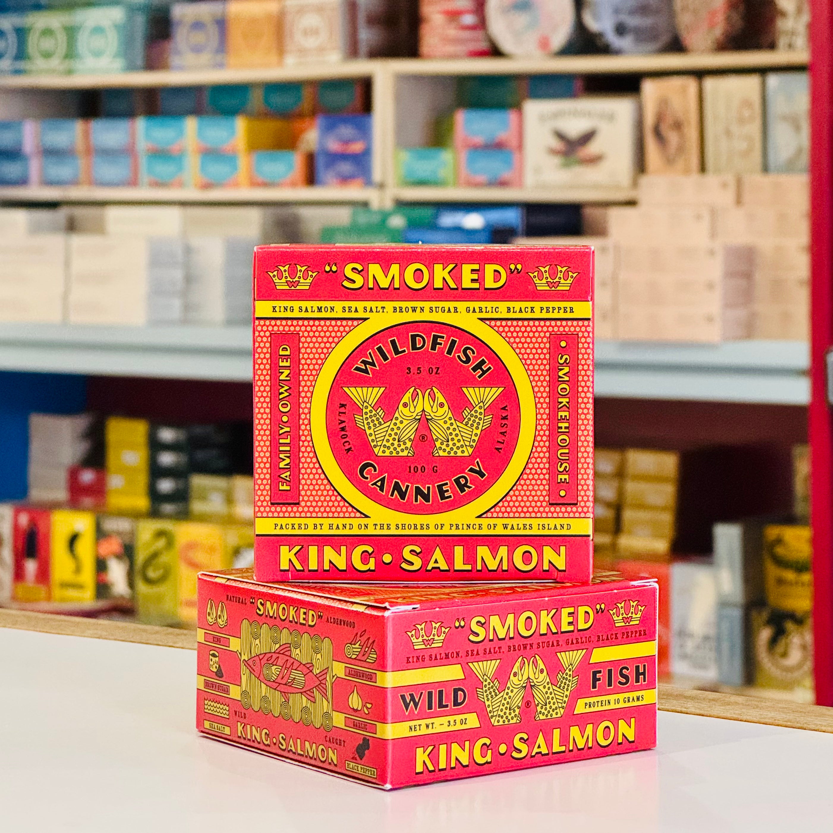 Two boxes of smoked king salmon from Wildfish Cannery on a shelf with other products.
