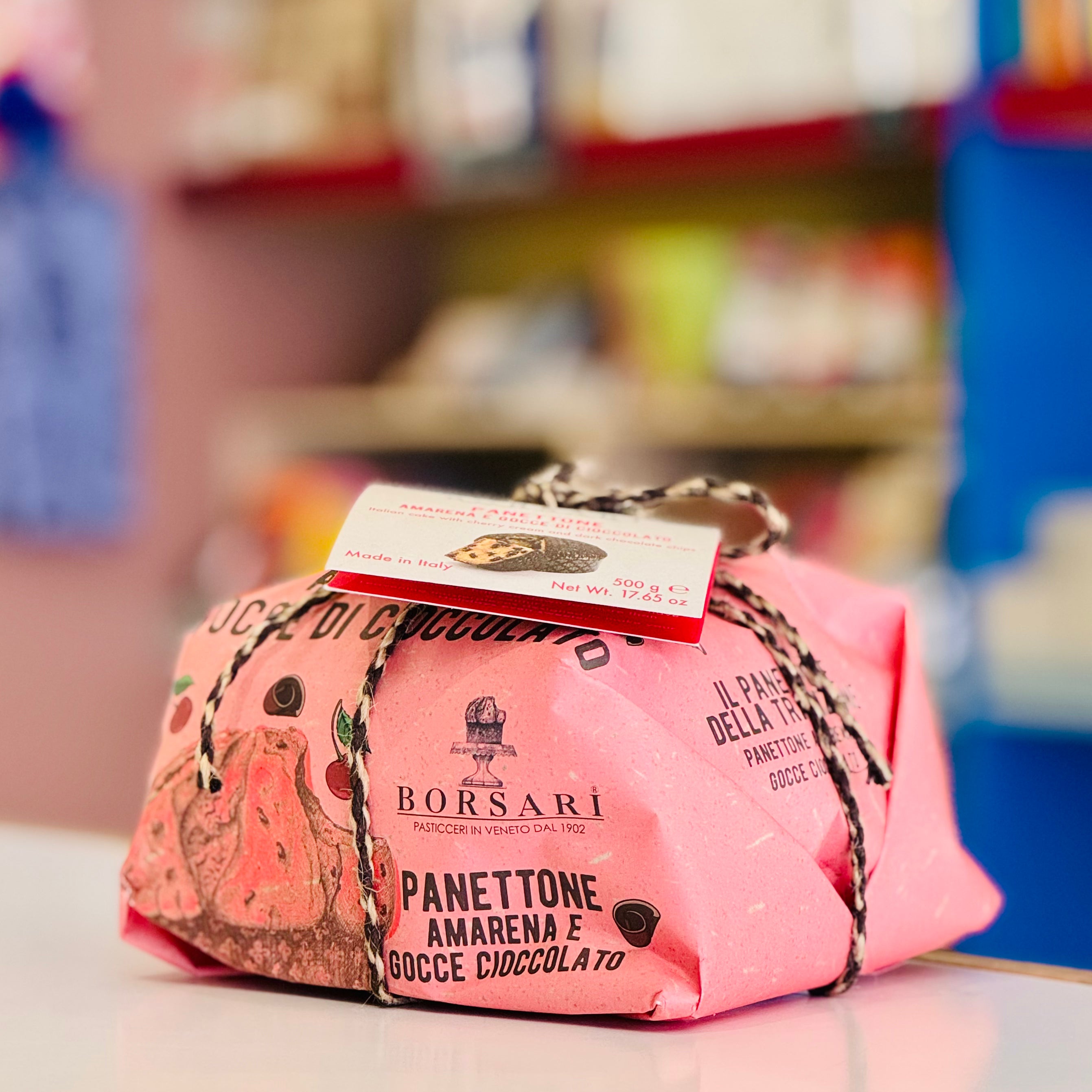 Pink panettone with a Borsari label on a blurred background