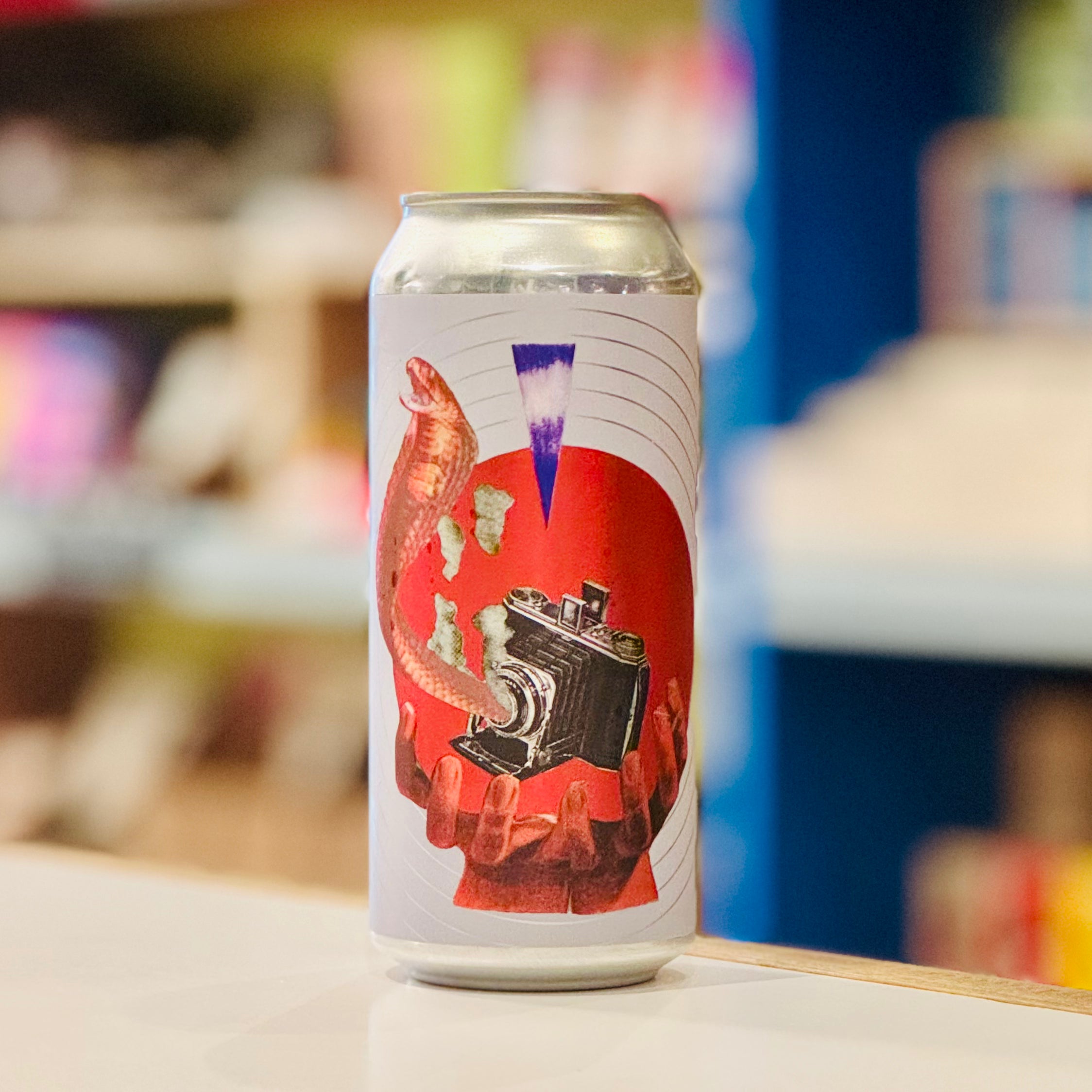 Beer can with artistic design on a blurred background