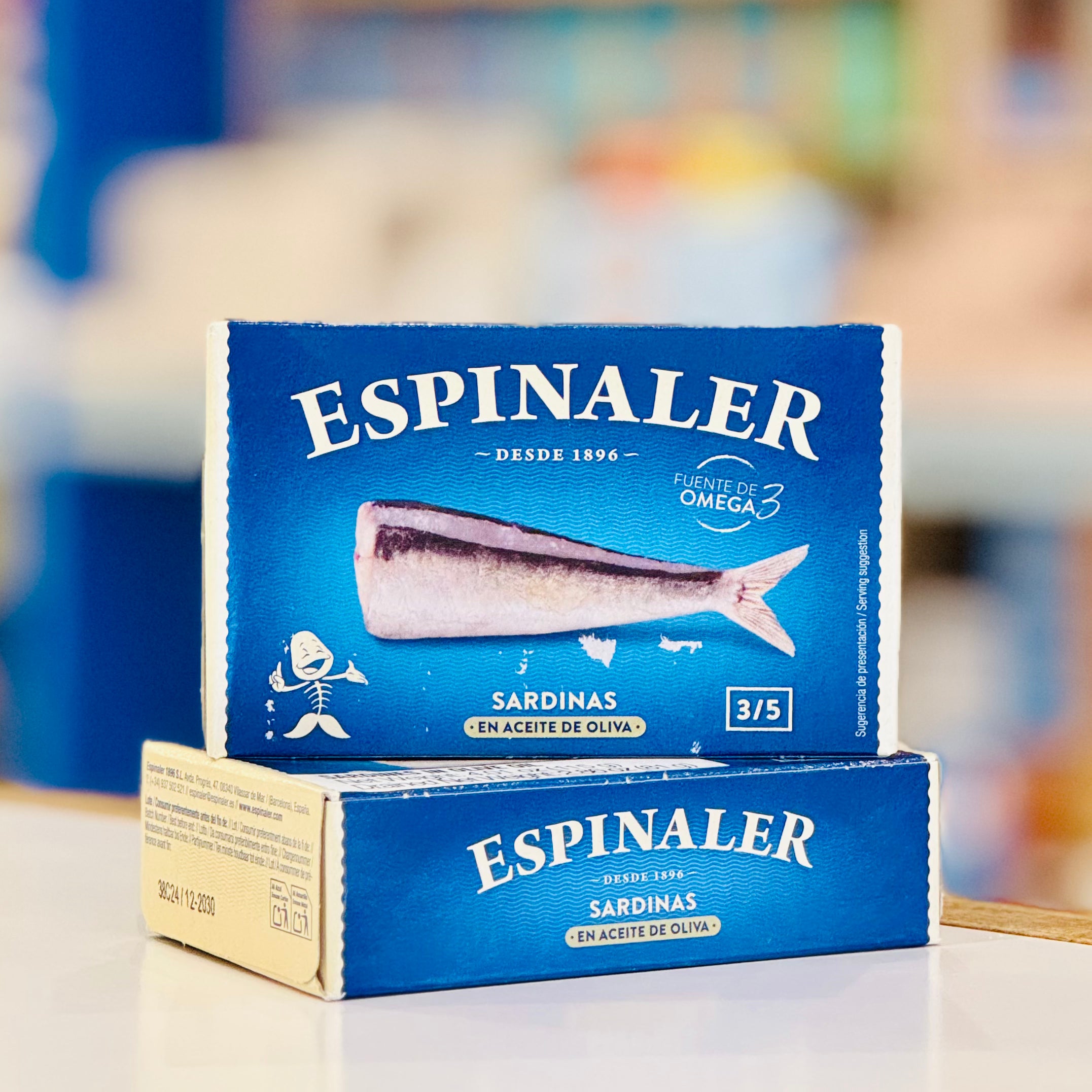 Espinaler sardine packaging on a blurred background