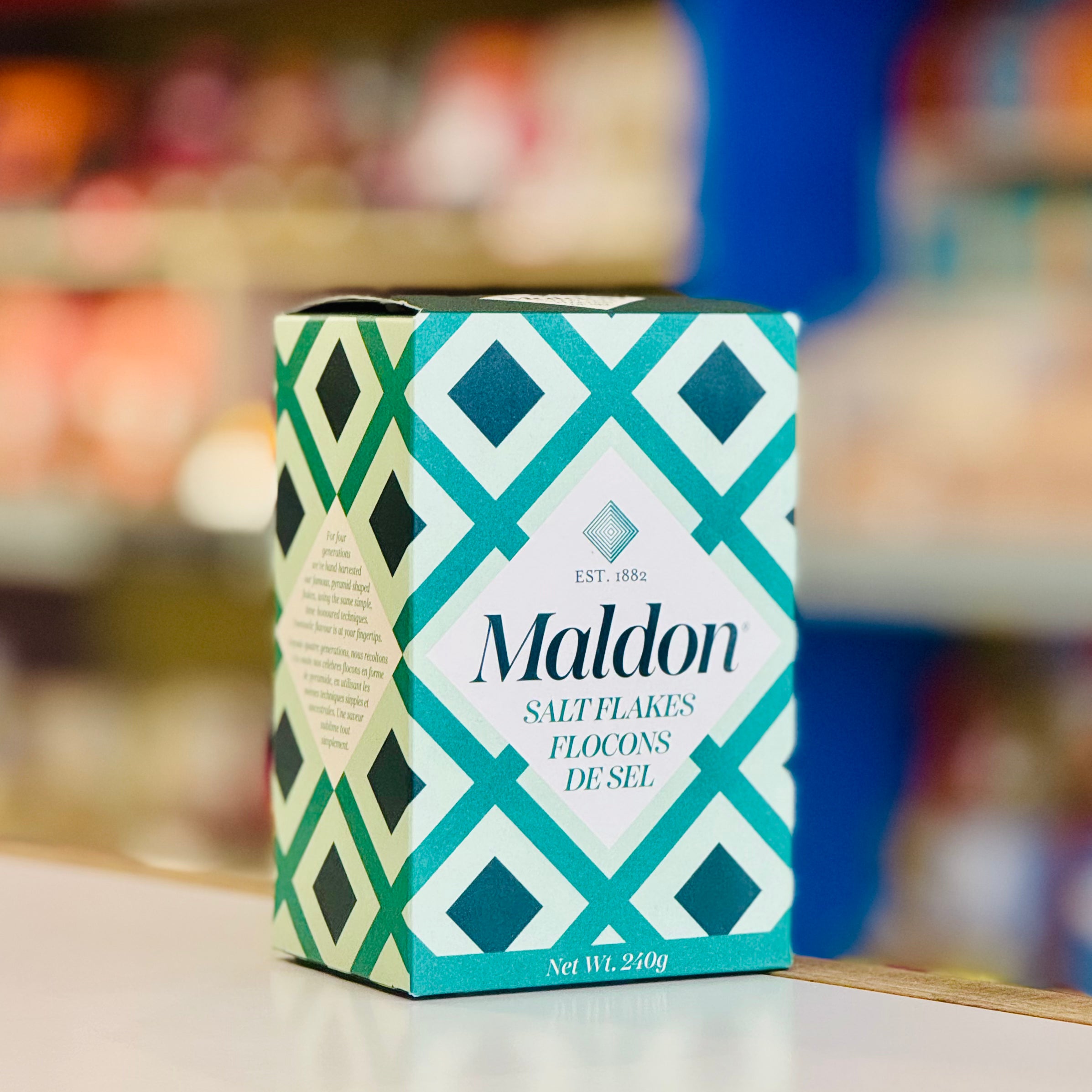 Maldon salt flakes packaging with geometric design on a blurred background