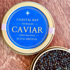 Coastal Bay Sturgeon Caviar container on a wooden surface