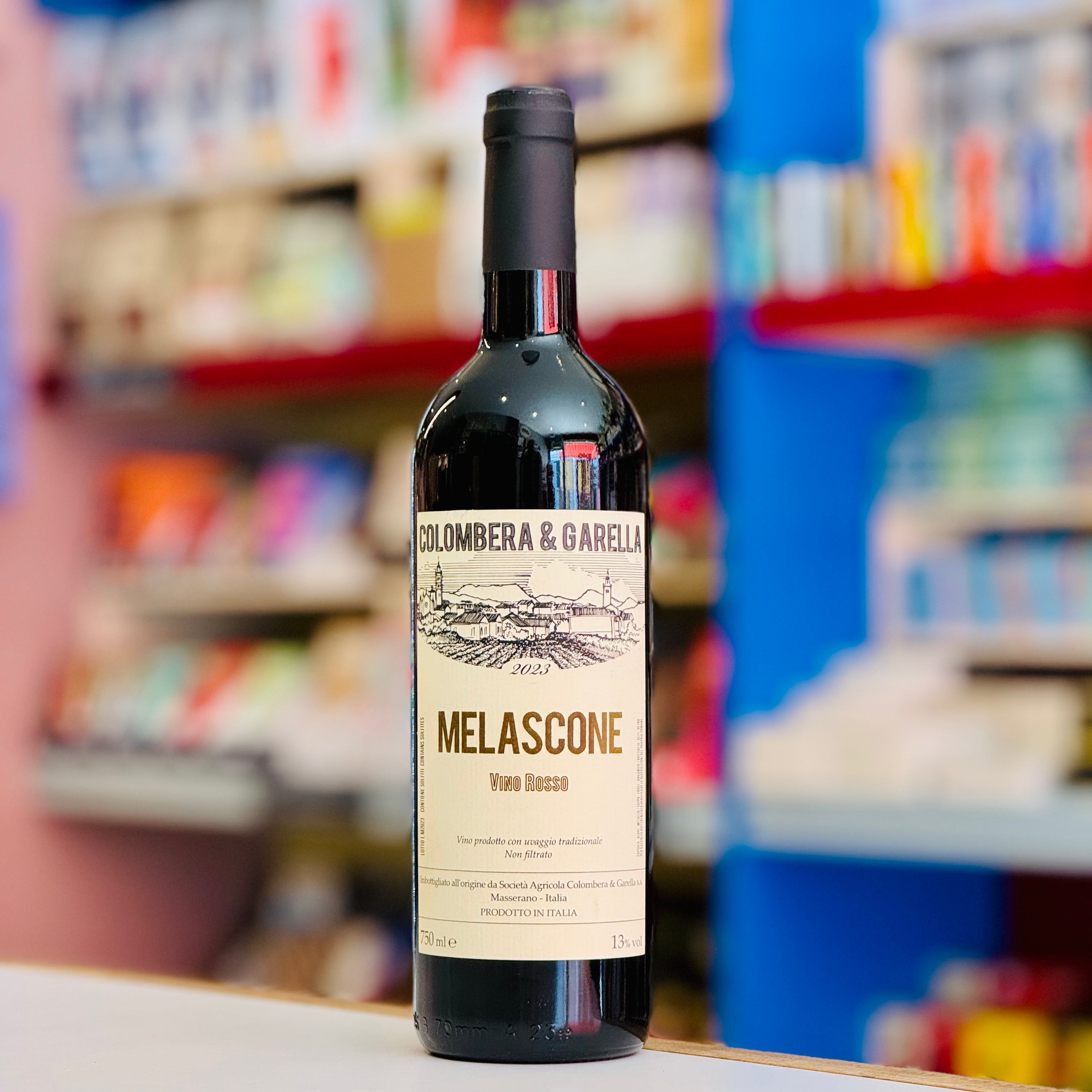 Bottle of Colombera & Garelli Melascone wine on a shelf with blurred store shelves in the background