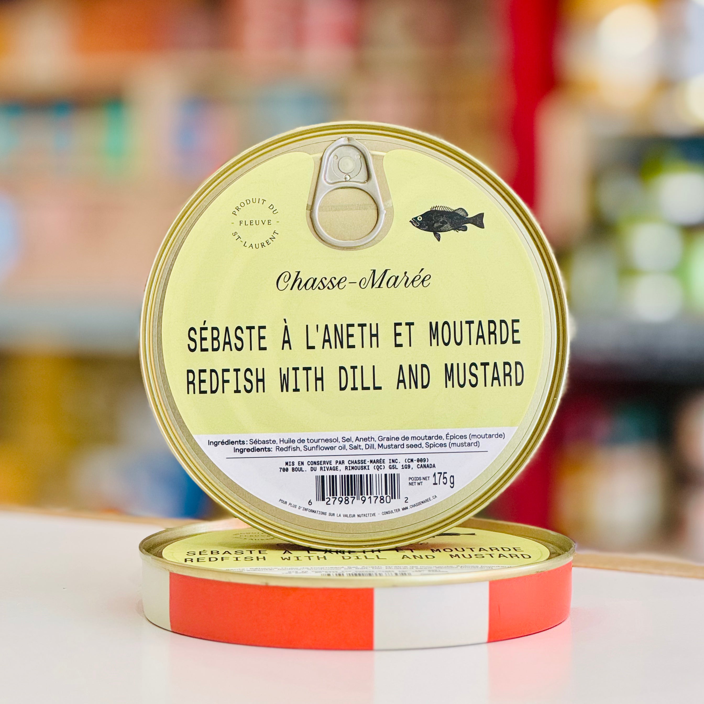 Can of Chasse-Maré redfish with dill and mustard on a blurred background