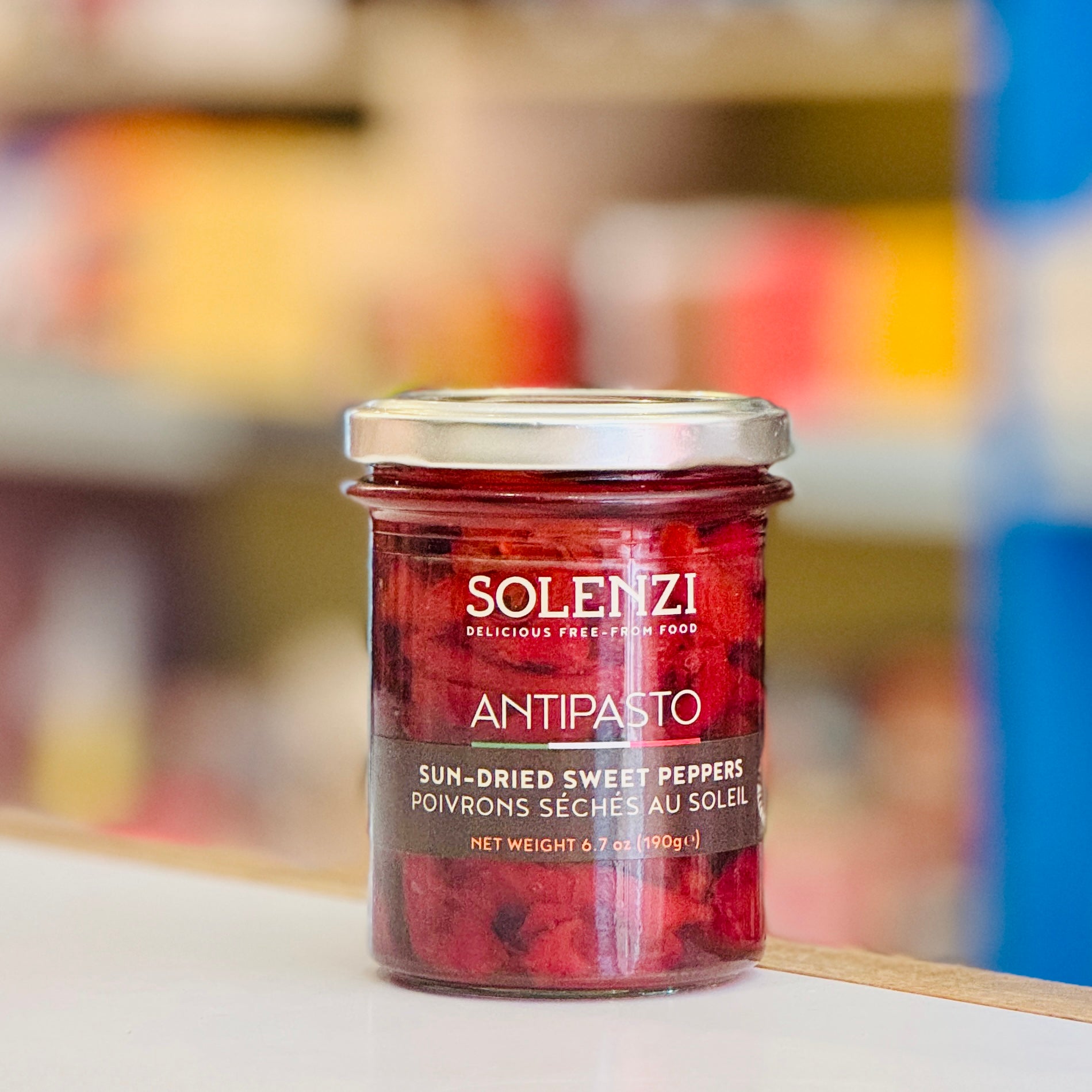Jar of Solenzi Antipasto sun-dried sweet peppers on a blurred background