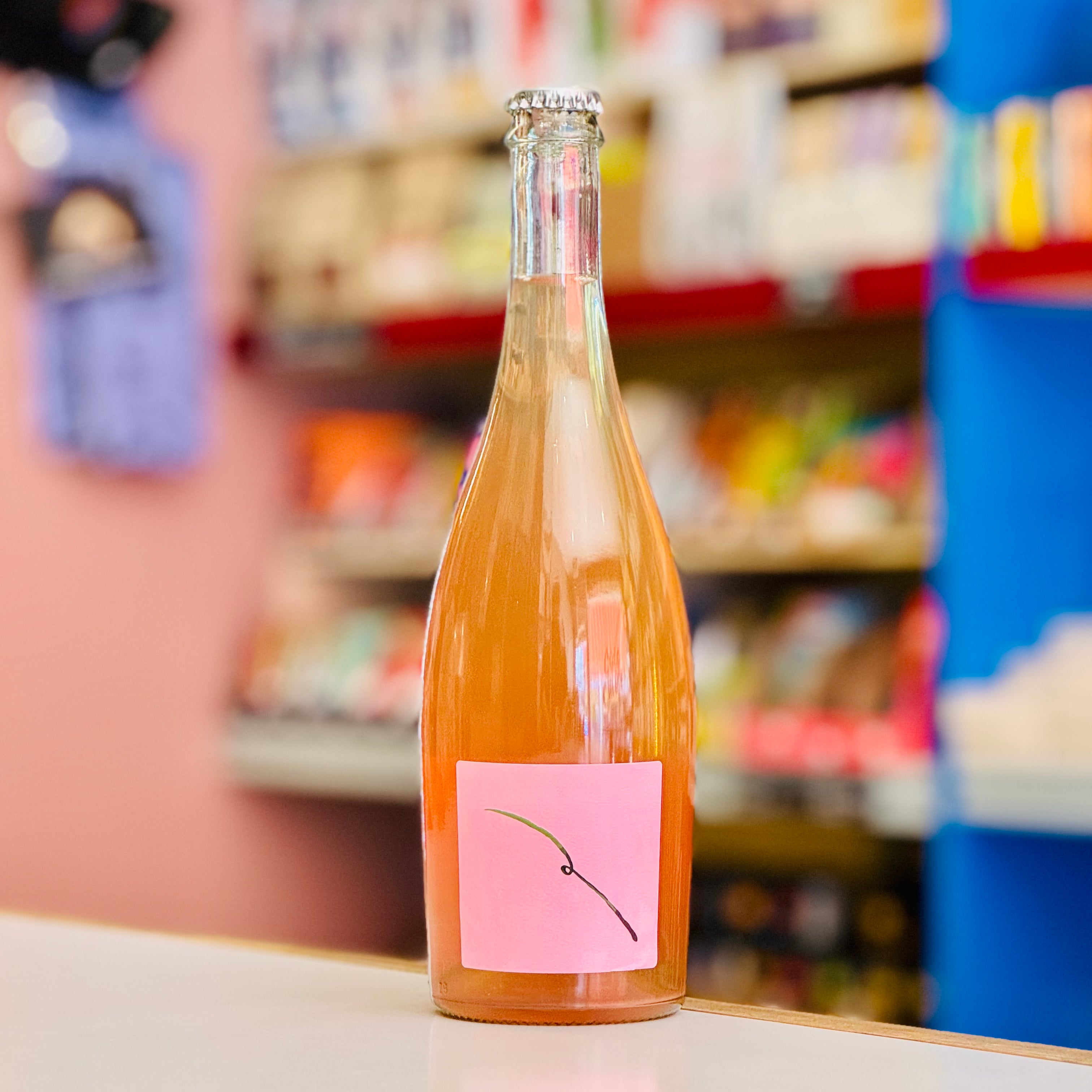 Orange bottle with a pink label on a shelf in a store