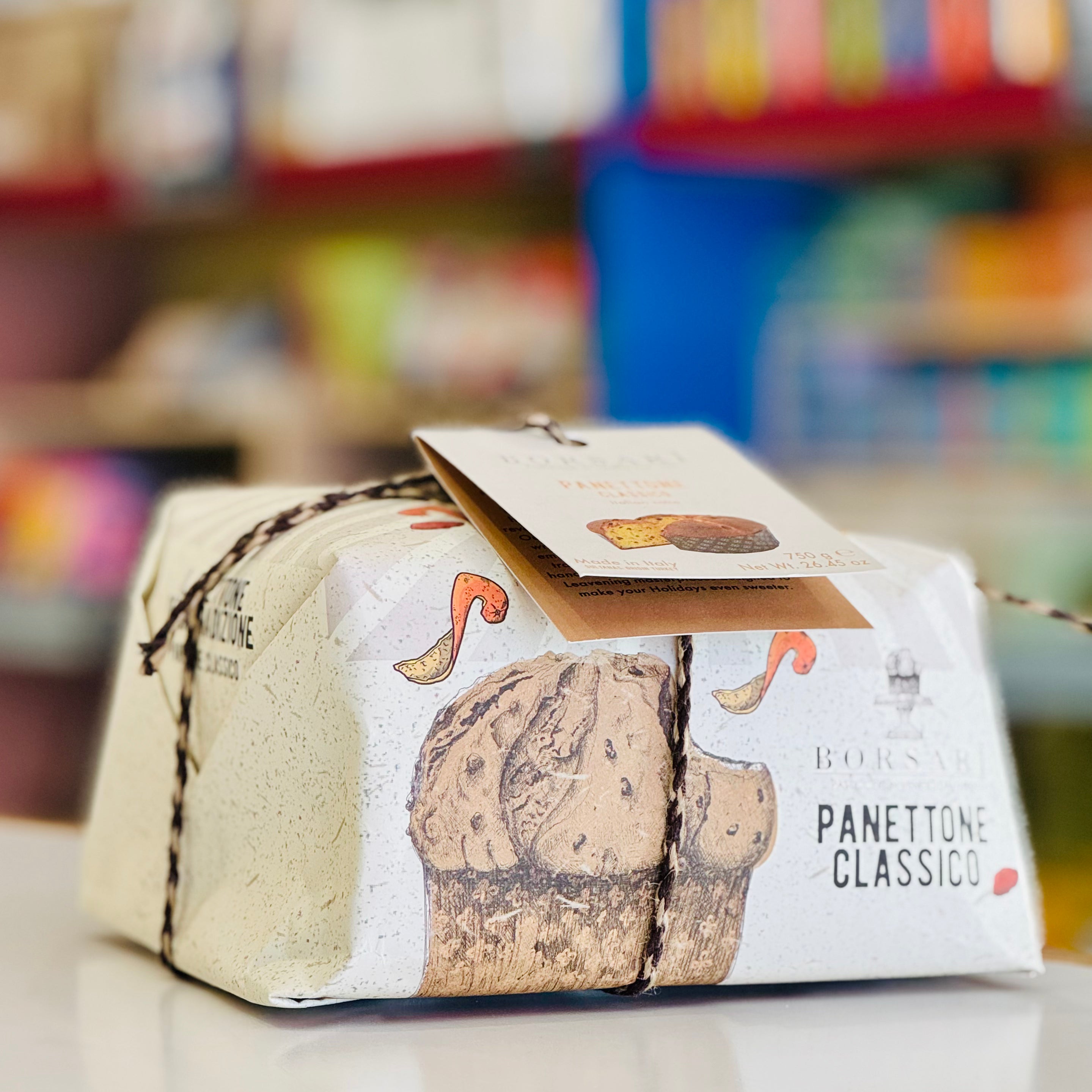 Panettone packaging with a blurred store shelf in the background