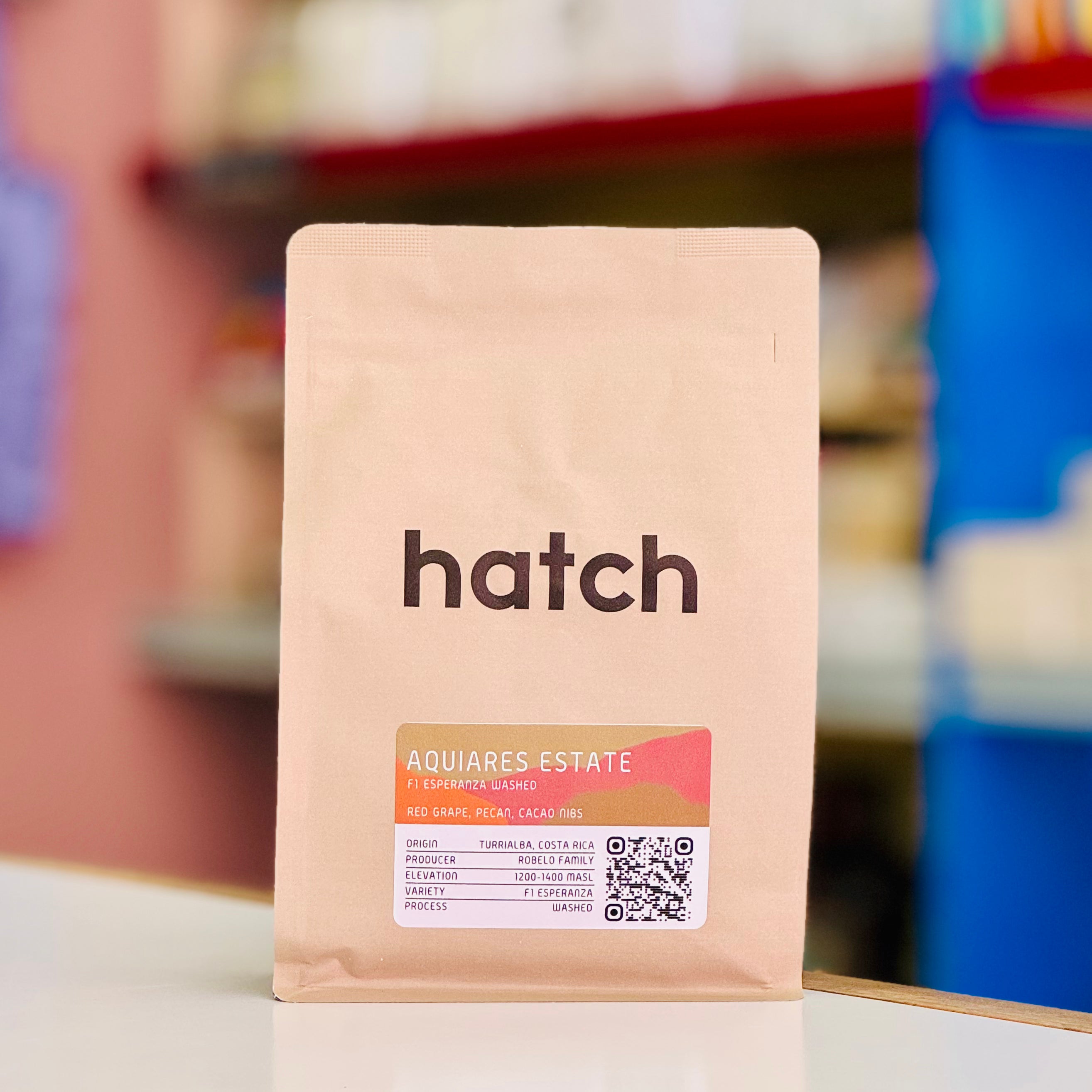 Hatch coffee bag with a blurred store shelf background