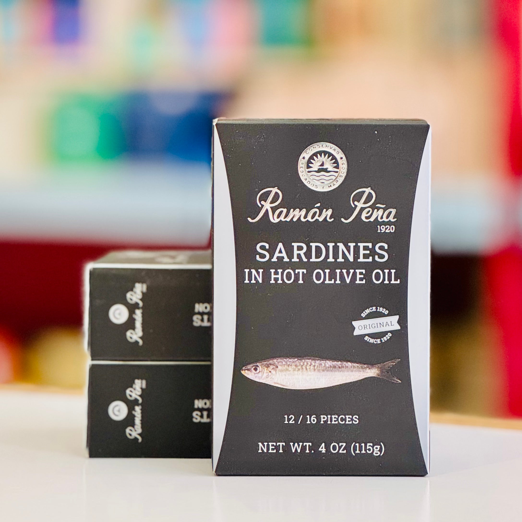 Ramon Pena sardines in hot olive oil packaging on a colorful background