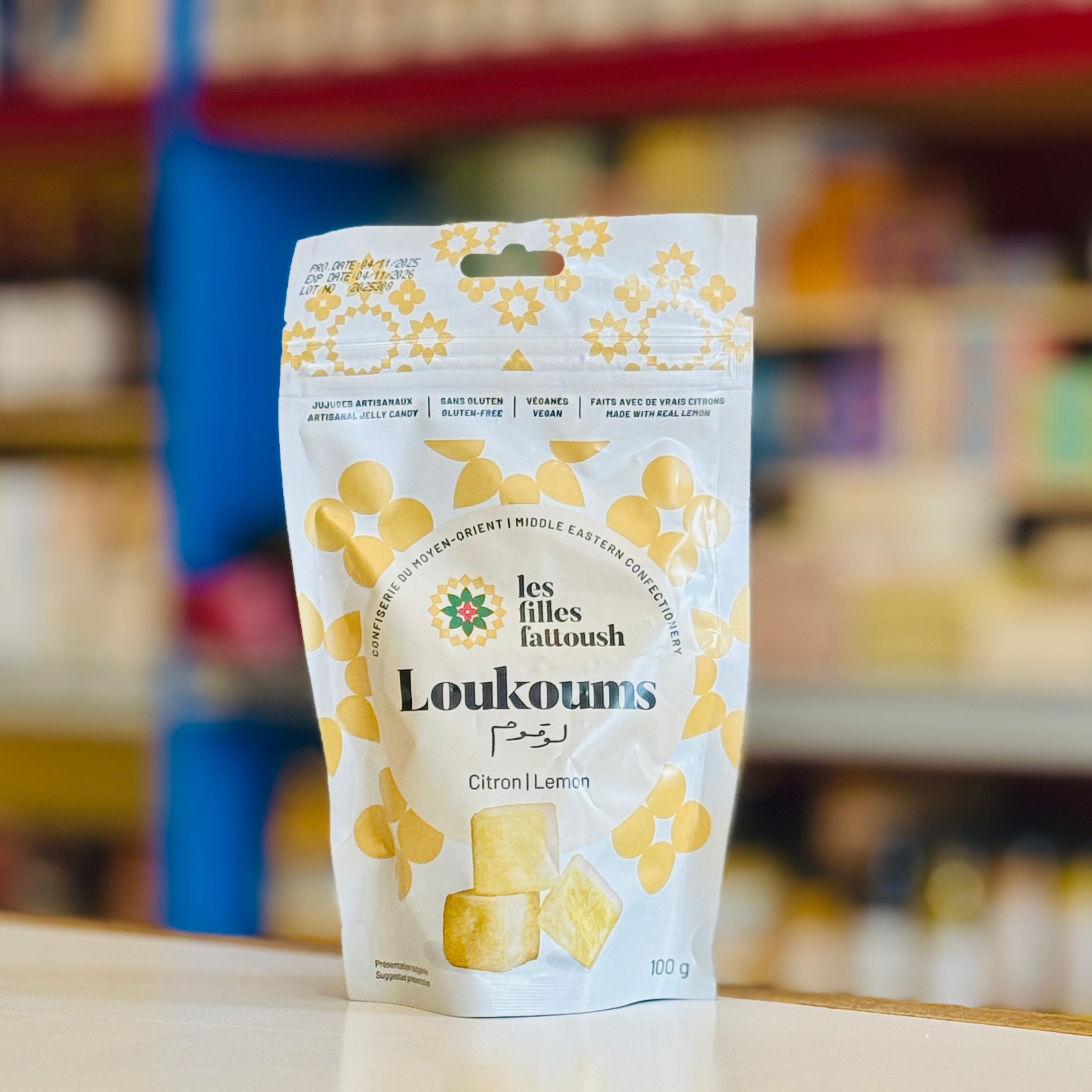 Loukoums packaging with lemon flavor on a blurred store shelf background
