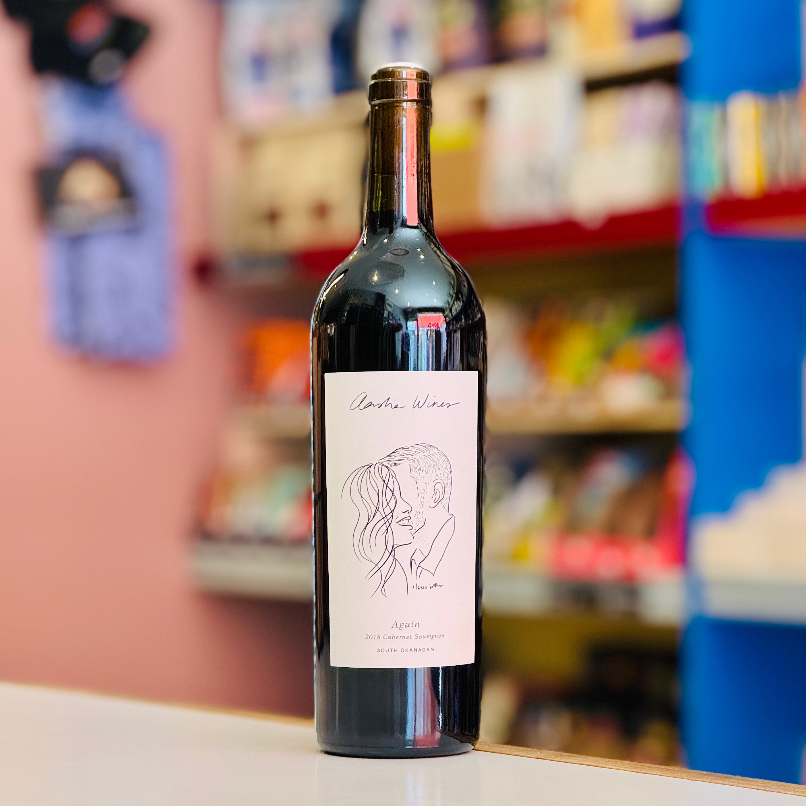 Red wine bottle with a label on a shelf in a store