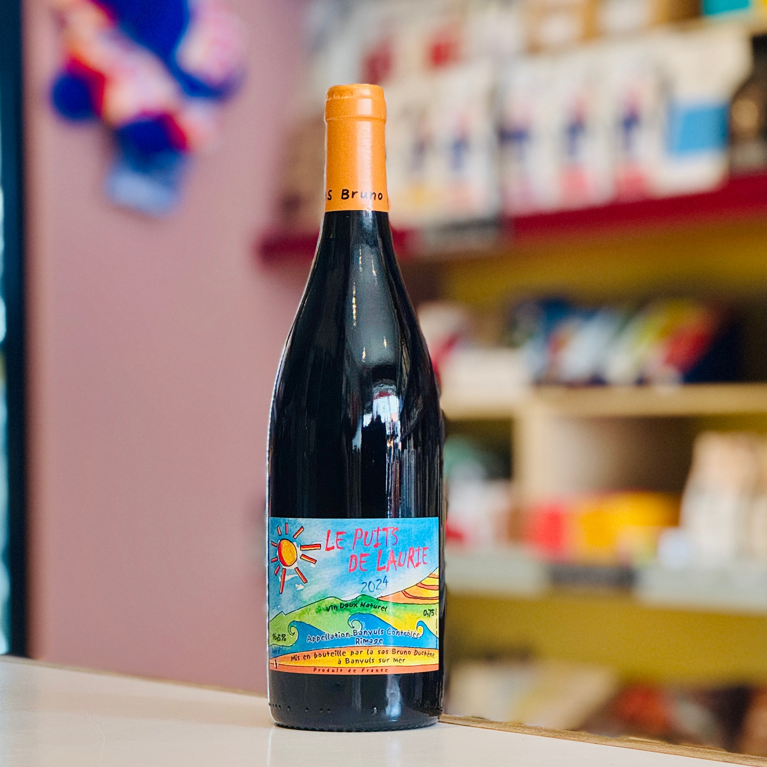 Bottle of wine with a colorful label on a shelf in a store