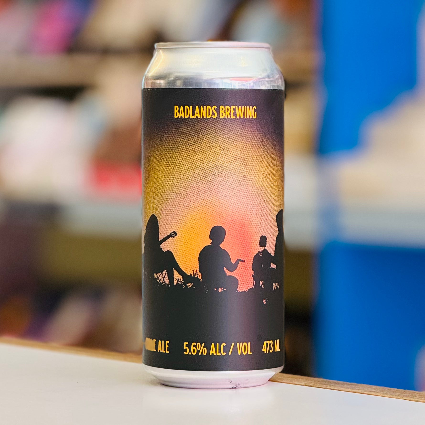 Beer can with Badlands Brewing branding on a blurred background