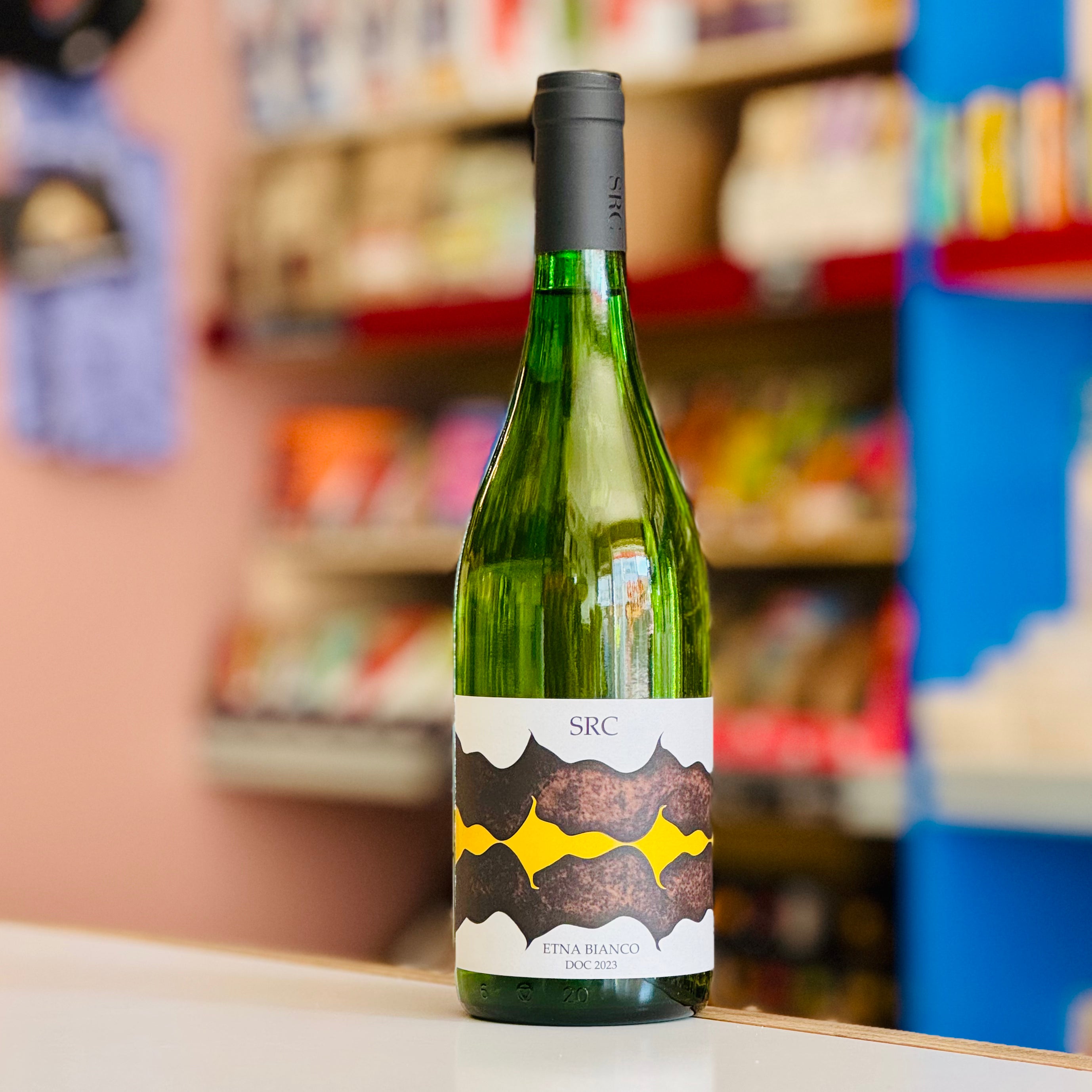 Green wine bottle with a label in a store setting