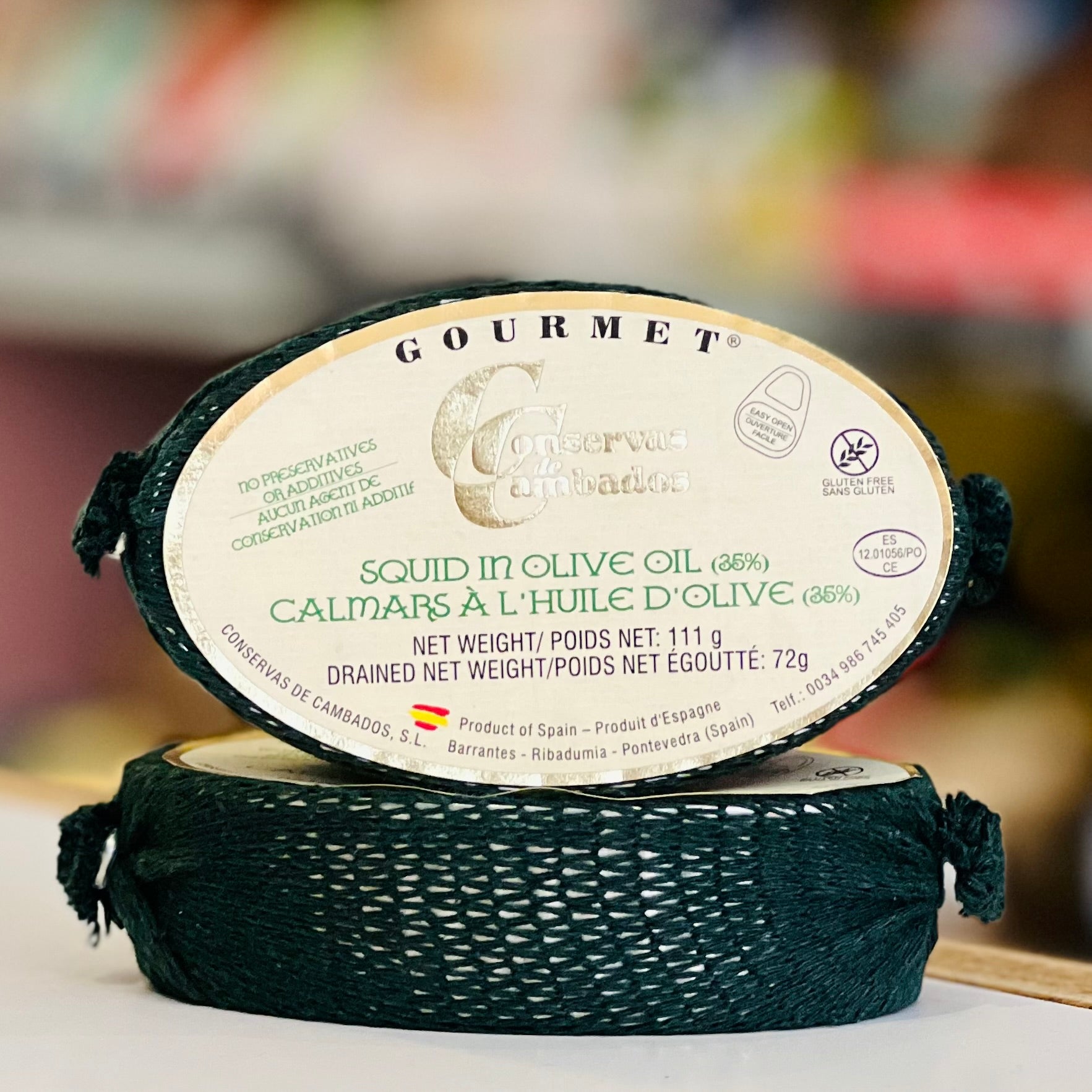 Gourmet squid in olive oil packaging with brand name on a blurred background