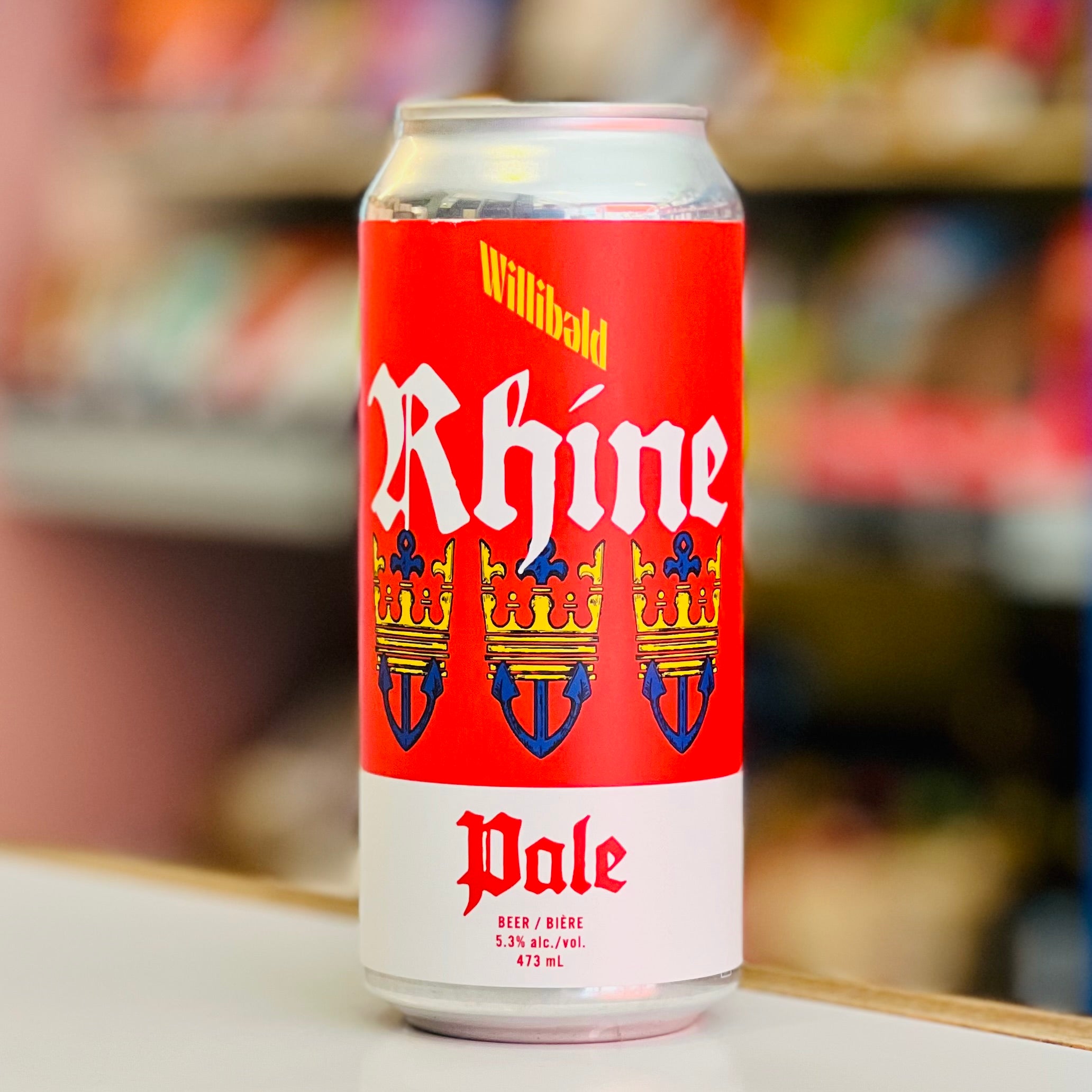 Red can of Willibald Rhine Pale beer with a blurred store shelf background