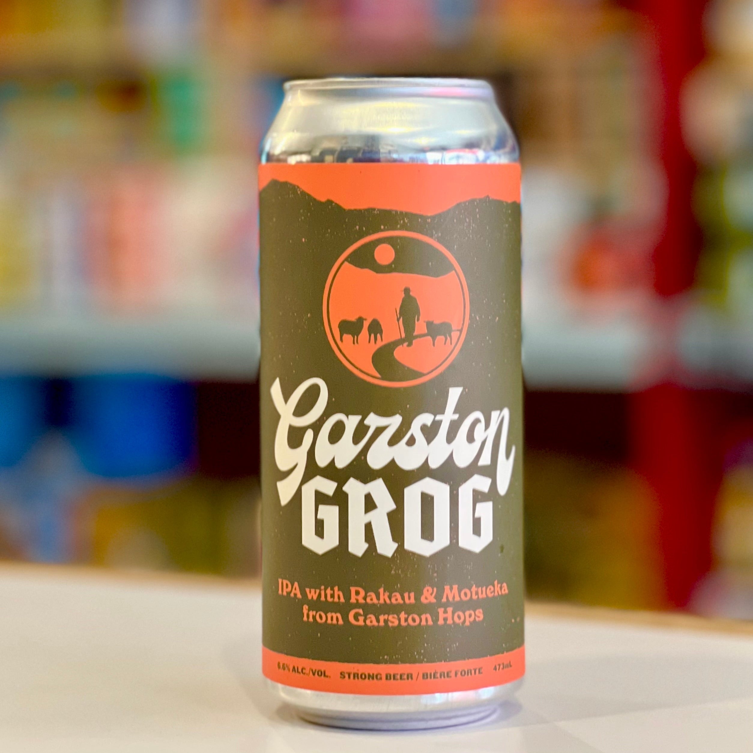 Can of Garston Grog IPA with a blurred store shelf in the background