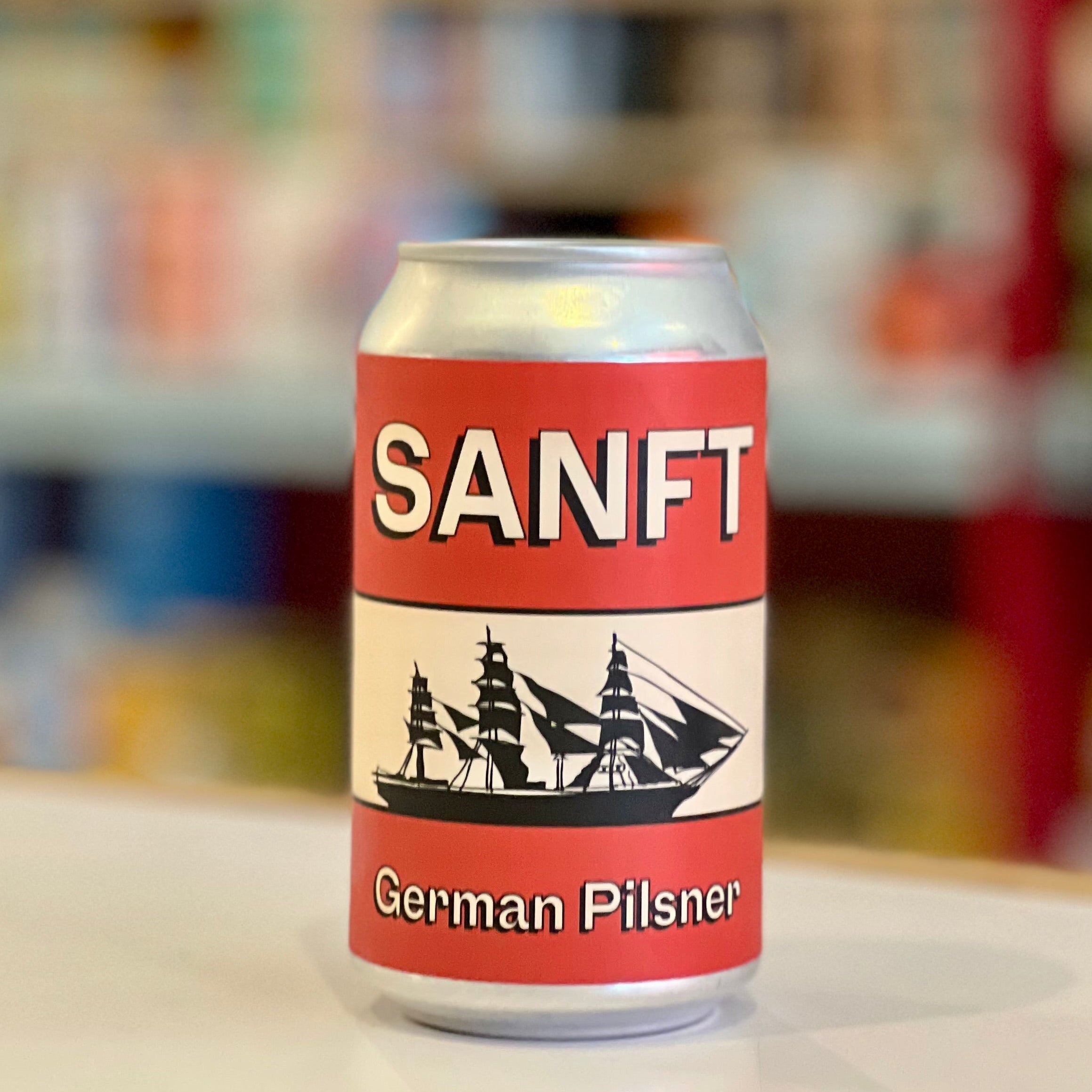 Can of Sanft German Pilsner on a shelf with blurred store background