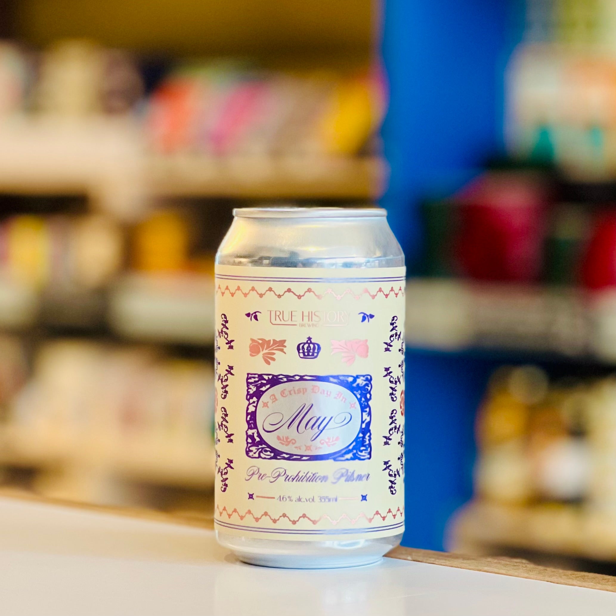 Beer can with decorative label on a shelf in a store