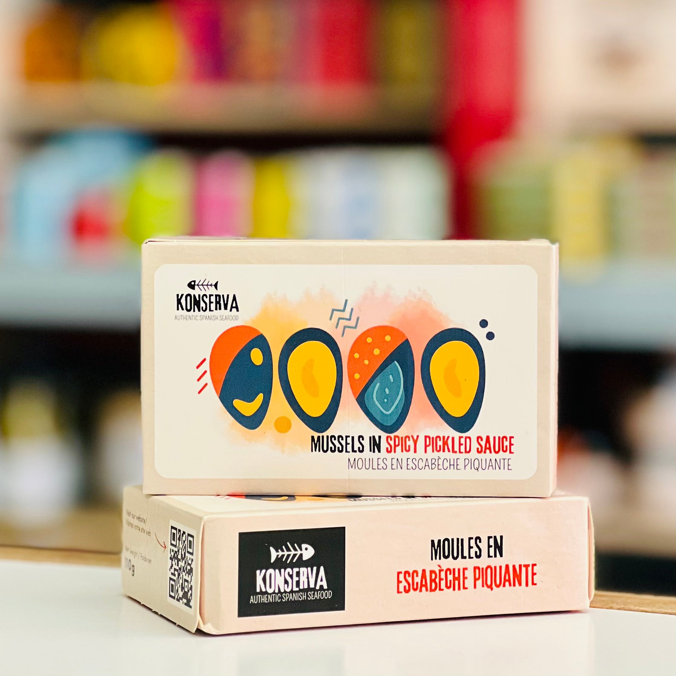 Konserva mussels in spicy pickled sauce packaging with colorful design on a blurred background