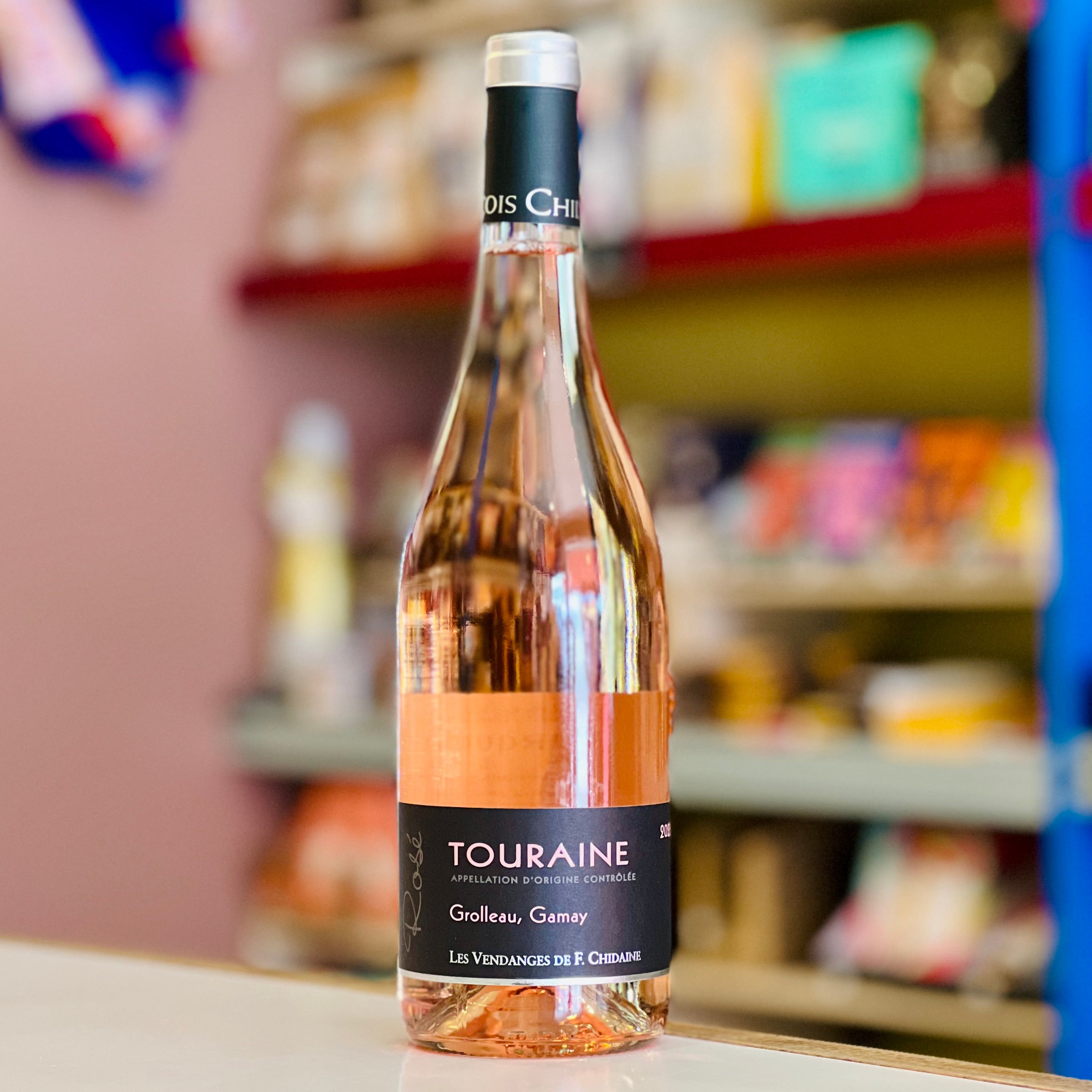 Bottle of Touraine wine with a blurred store shelf in the background